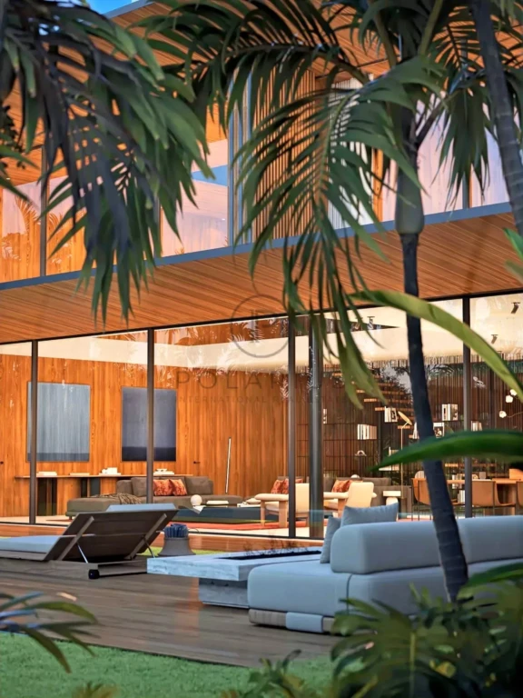 Une maison moderne avec de grandes baies vitrées, entourée de végétation tropicale.
