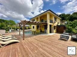 Maison spacieuse avec une grande terrasse et une piscine, idéale pour la détente et les loisirs.