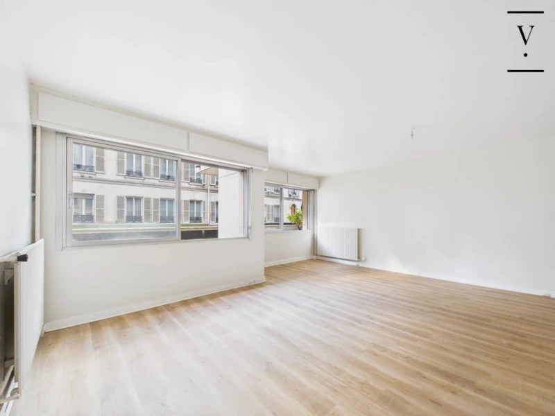 Salon lumineux et spacieux avec deux baies vitrées.