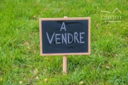 blackboard with text in french "for sale" on a grass