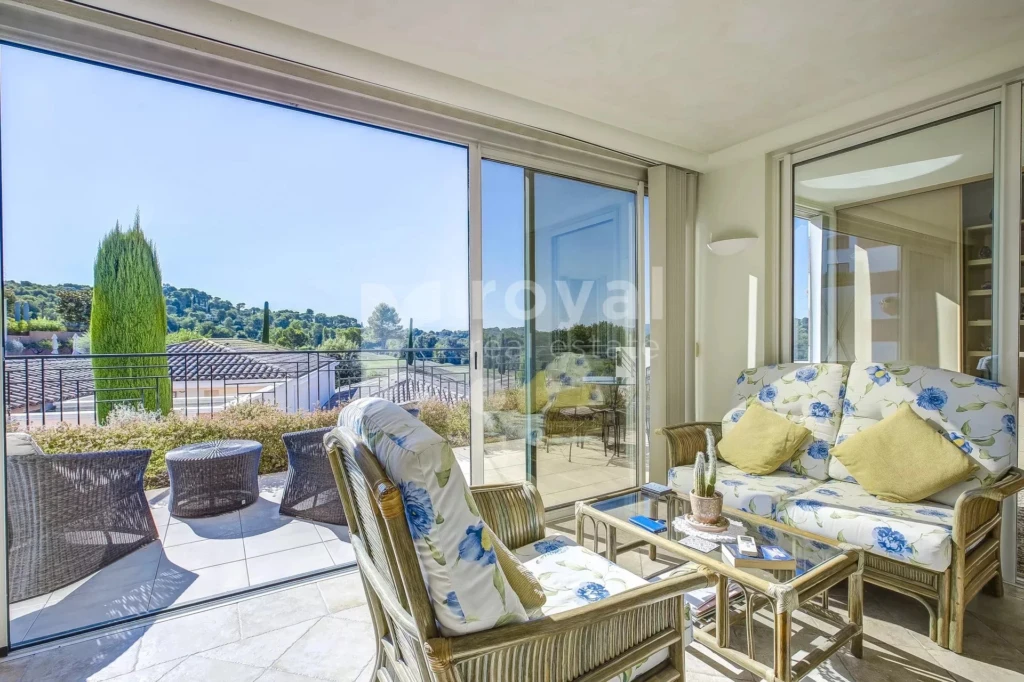 Véranda lumineuse prolongée par la terrasse au Mougins Golf
