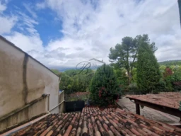 LA BASTIDE DES JOURDANS, An empty room with white walls and a red-tiled floor features a window and